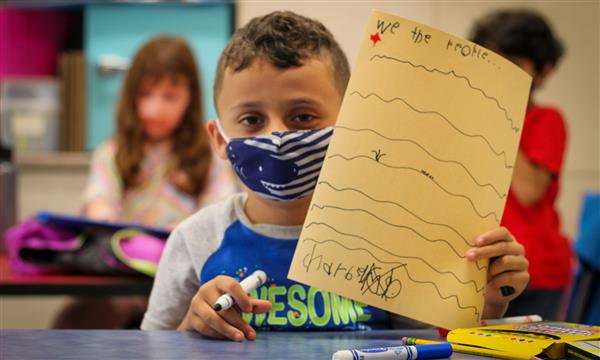Boy holds up Constitution craft